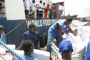 Casual Laborers with the WFP (World Food Program) load food rations onto a truck in the Free Port of Monrovia.